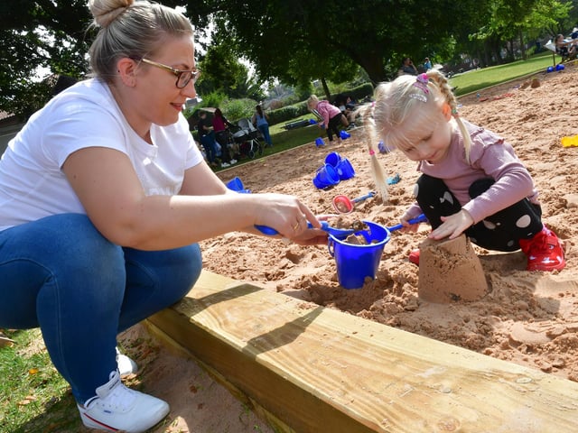 Practising sandcastle building are Marta Szerlot with Amelia Szerlot, aged three, of Boston.