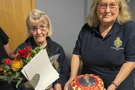 Marjorie Kavanagh (left) is honoured for her 30 year's service to the Royal British Legion, including a cake baked by Margaret Jarvis.