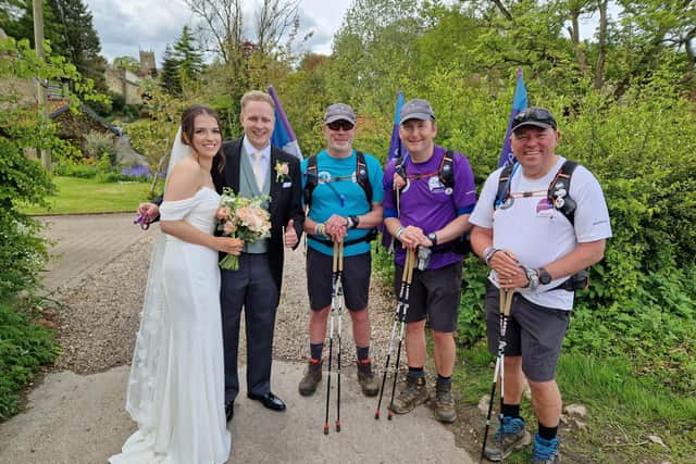 Fund raising champions 3 Dads Walking made their way through Tealby , just as Liv and Josh were having their wedding photos taken. Does this count as photobombing? Image Lawrence Brown