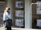 A woman looks at adverts in the window of an estate agent. Picture: DANIEL LEAL-OLIVAS/AFP via Getty Images.