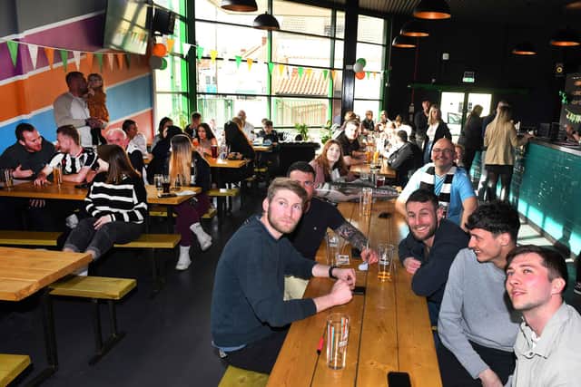 Supporters in the Tap on the Line watching the Brighton vs Grimsby match.