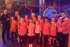 The team show off their new shirts as they get ready for a day of fun.