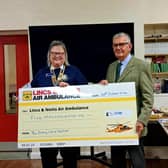 Rotarian Paula Ireland presents the £5,000 raised to chairman of trustees at the air ambulance charity, Graham Secker.