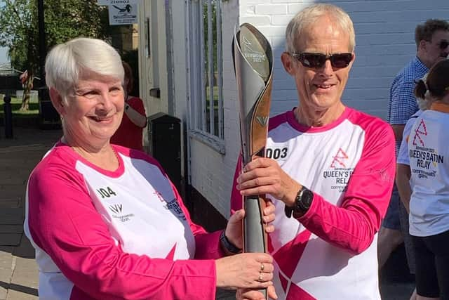 Linda Baxter and Peter Ward with the baton.