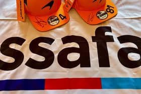 Image 1: The New Era caps signed by Lando Norris and Oscar Piastri.