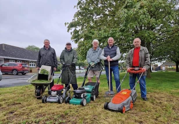 Residents who have started cutting the grass themselves pictured with Coun Steve O'Dare (second right).