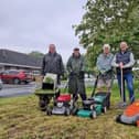 Steve Hinsley (third right) and the residents who have been  cutting the grass themselves pictured with Coun Steve O'Dare (second right), who seconded the motion.