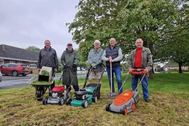 Steve Hinsley (third right) and the residents who have been  cutting the grass themselves pictured with Coun Steve O'Dare (second right), who seconded the motion.