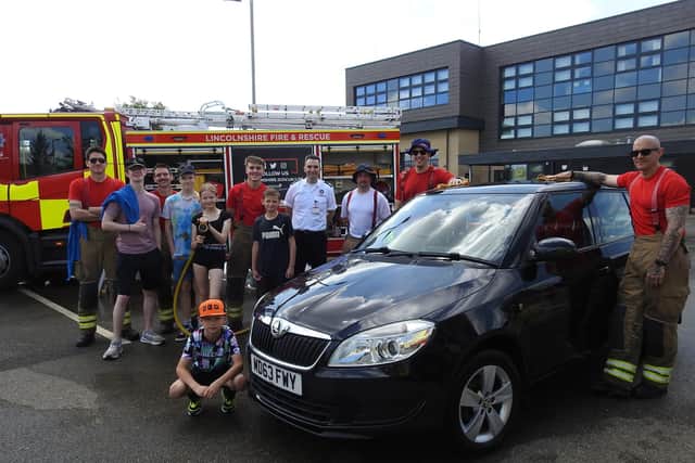 Sleaford firefighters and cadets put the finishing touches to another clean car during their charity car wash event at Sleaford fire and ambulance station.
