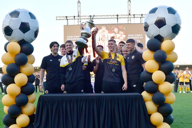 Boston United first team players hold the play off trophy aloft. Photo: David Dawson