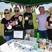 Lily's Rainbow Fund family fun day, pictured with Lily's pebbles painted by Lily's great-grandma Barbara Shaw (right) are Claire Coulam, Erica Adams, Bill Adams, and Steve Coulam.