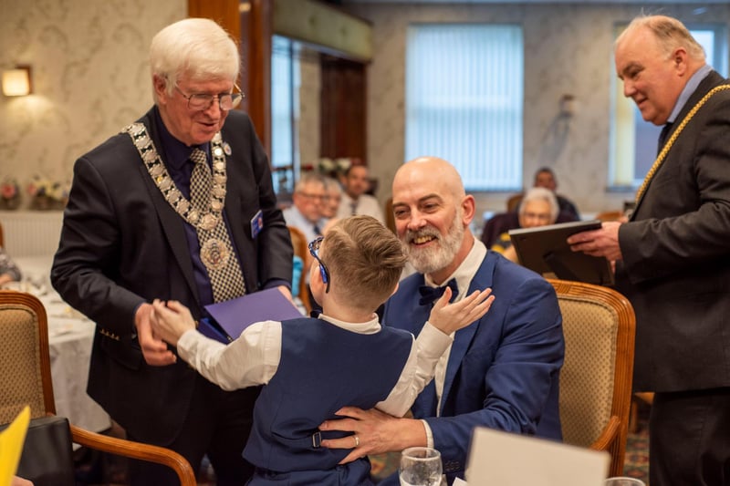 Tom, pictured with his dad, is presented with his award by Rotarian David Kendrick.