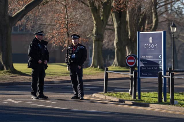 Police officers stand guard inside Epsom College after the school's head, Emma Pattison, was found dead alongside her family  on February 6, 2023 in Epsom. Pattison, her husband George, and 7-year-old daughter Emma were found dead in a property on school grounds early on Sunday morning. (Photo by Carl Court/Getty Images)