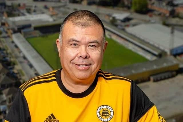 Sir Jonathan Van Tam wearing a Boston United shirt.