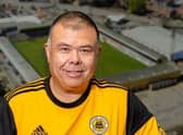 Sir Jonathan Van Tam wearing a Boston United shirt.