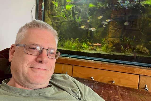 Boston man Phil Landshoft pictured with one of his four fish tanks.