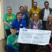 Supporters of The Lincolnshire & Nottinghamshire Air Ambulance hand over £1,000 to Helen Hall and Andrew Jarvis, volunteers of the charity.