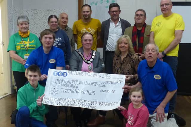 Supporters of The Lincolnshire & Nottinghamshire Air Ambulance hand over £1,000 to Helen Hall and Andrew Jarvis, volunteers of the charity.