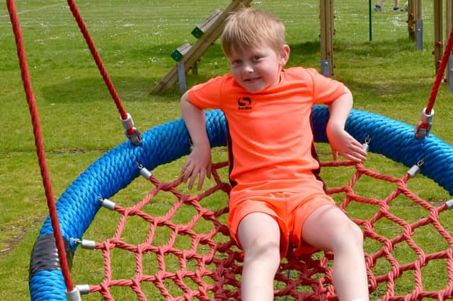 Reuben Penny, six, on the new basket swing.