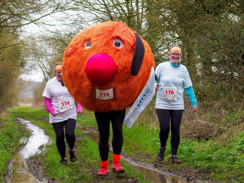 Paul Bagshaw running the fun run dressed in a giant orange costume to raise funds for Shine Lincolnshire.