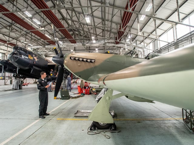Squadron Leader Mark Long inspecting the Hurricane