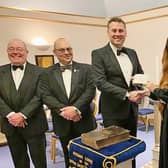 Lucy Goodchild, Shine’s Communications and Engagement Manager, receives the donation from Lincoln Freemasons.