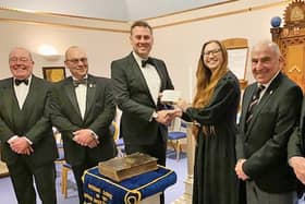 Lucy Goodchild, Shine’s Communications and Engagement Manager, receives the donation from Lincoln Freemasons.