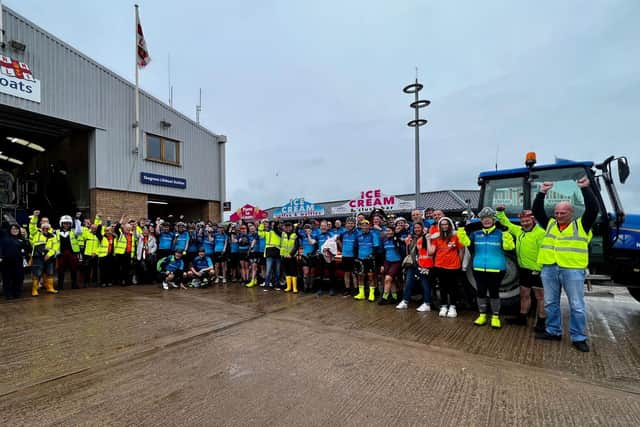 The cyclists with RNLI crew at the RNLI station in Skegness.