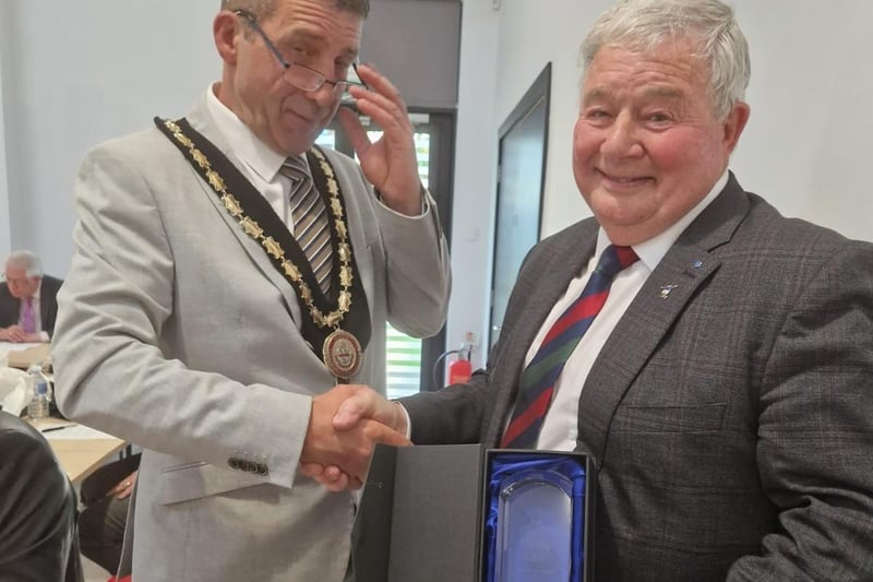 New Mayor Coun Adrian Findley gives a presentation to the outgoing Mayor Coun Pete Barry for his service.