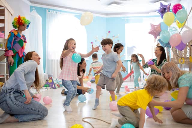 Children and their parents entertain and have fun with balloons