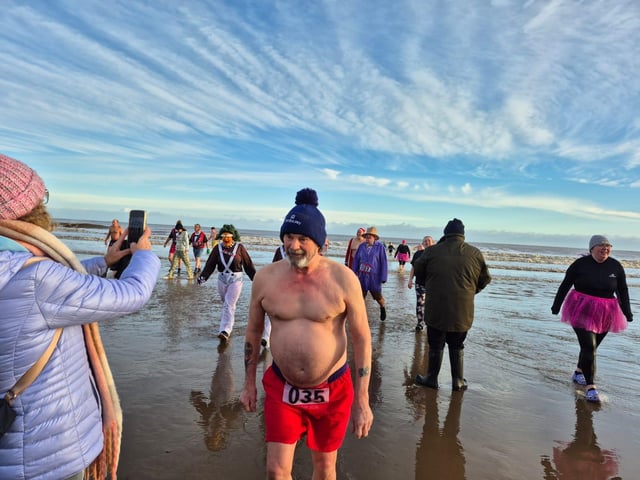 Dippers return from their bracing charity swim at Mablethorpe. Photo: Carl Tebbutt