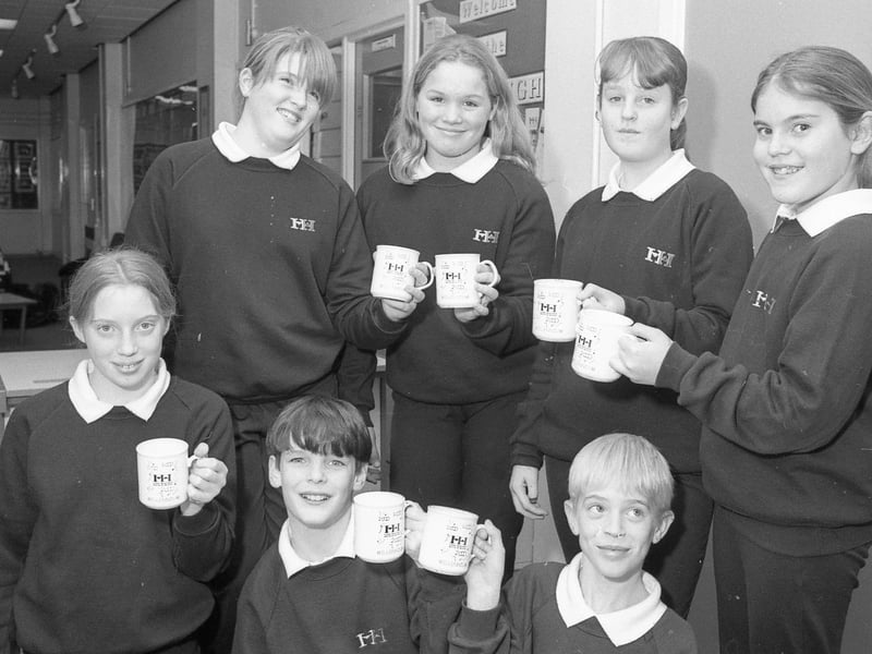 Haven High School pupils holding mugs that had been designed by pupil Rochelle Taylor to make the millennium. Every pupil and member of staff were to be presented with one of the mugs as a souvenir of the year 2000. Rochelle is pictured, alongside fellow pupils, second right on the back row.