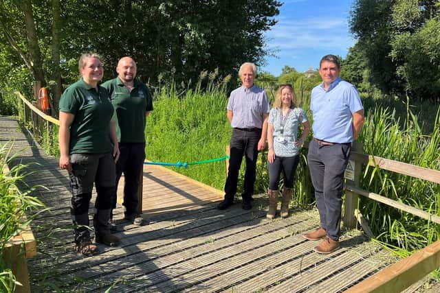 A new extension of the boardwalk around the pond at Lollycocks Field is helping protect vegetation and wildlife around the pond edges, while improving access and enjoyment of the site for all. From left - Hill Holt Wood Head of Business and Quality Hollie Drake and Head Ranger Ben Wilson, NKDC Executive Board Member Coun Mervyn Head, South Kesteven District Council Regeneration Project Manager Tracey Mooney, and Environment Agency Catchment Co-ordinator (Witham and Ancholme) David Hutchinson.