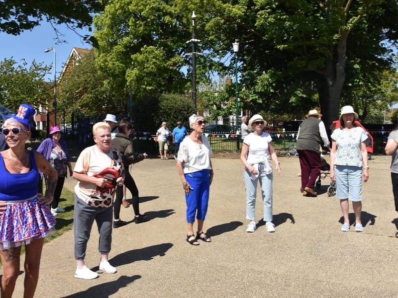 Line dancing at the picnic in the park.