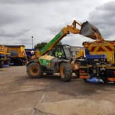 Loading the gritter up with sand to help melting roads.