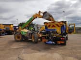 Loading the gritter up with sand to help melting roads.