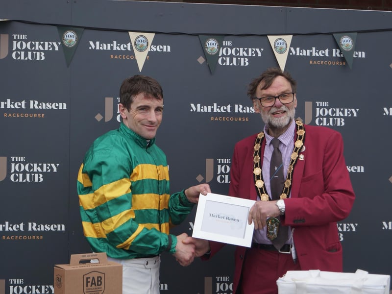 Jockey Brian Hughes collected the prize from Coun Stephen Bunney after his win on Grand D'Oudairies in the Market Rasen Town Council 50th Anniversary Handicap Steeple Chase