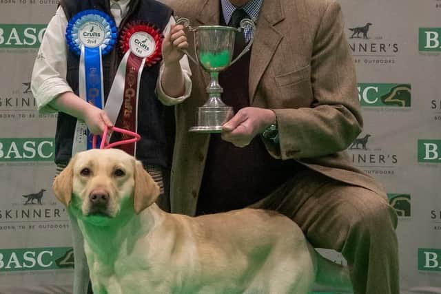 Elodie, pictured with Drift, is presented with her trophy by Ian Grindy, a member of the BASC Council. Image: Nigel Kirby Photography