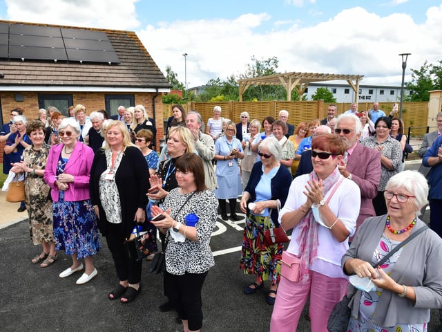 A crowd of supporters gather to watch the official opening.