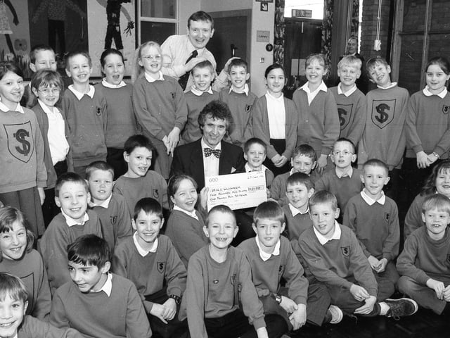 Youngsters at St Thomas Primary School, Boston, raised £431 for Pilgrim Hospital's MRI Scanner Appeal through a sponsored silence in 1999. Pupils from Jonathan Coffey's class are pictured with their teacher as they hand over the cheque to Dr Cyril Nyman.