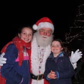 Father Christmas meets Isla, nine, and Lucy, 6, Garnett after switching on the Christmas tree lights in Navenby.