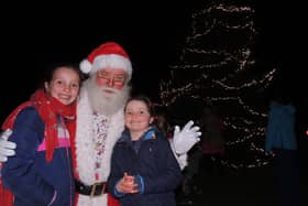 Father Christmas meets Isla, nine, and Lucy, 6, Garnett after switching on the Christmas tree lights in Navenby.