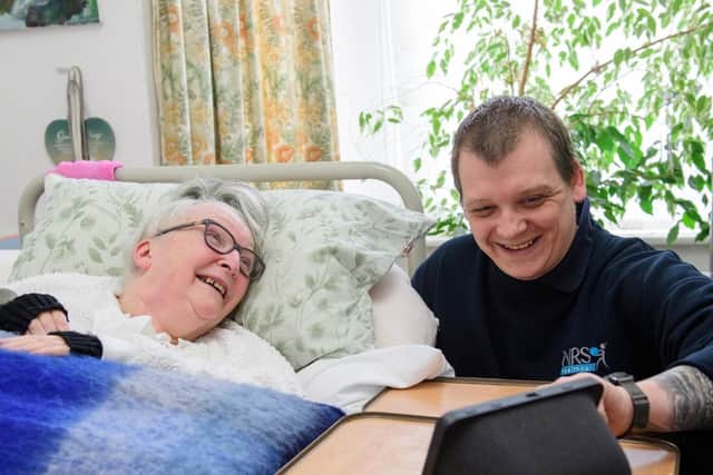 Gainsborough resident Veronica Eden learns from care technology consultant Dan Clarke how to get the best out of her new system