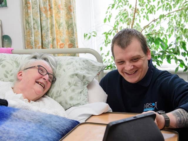 Gainsborough resident Veronica Eden learns from care technology consultant Dan Clarke how to get the best out of her new system