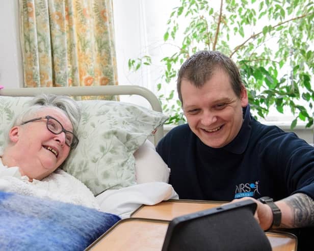 Gainsborough resident Veronica Eden learns from care technology consultant Dan Clarke how to get the best out of her new system