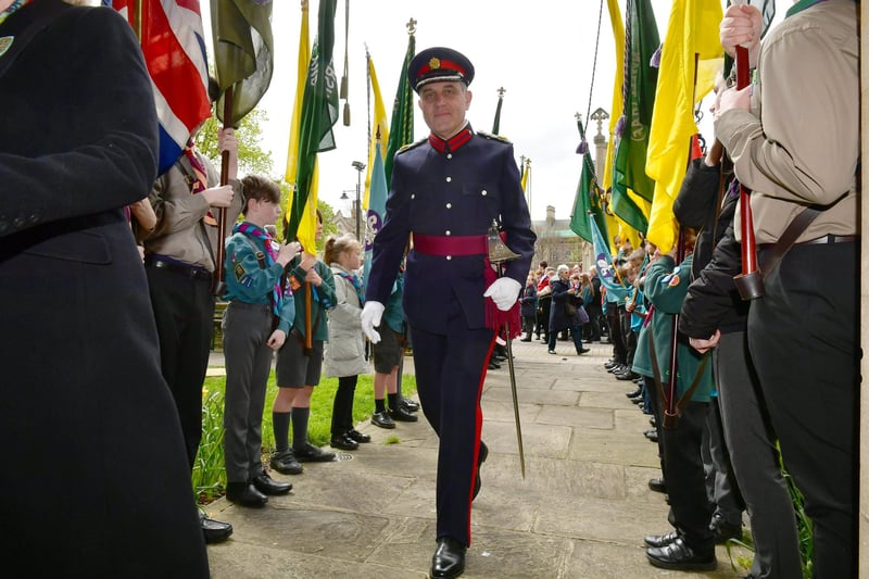 Charles Pinchbeck, Deputy Lord Lieutenant of Lincolnshire, heads into St Denys' Church between the rows of Scout standard bearers. Photo: David Dawson