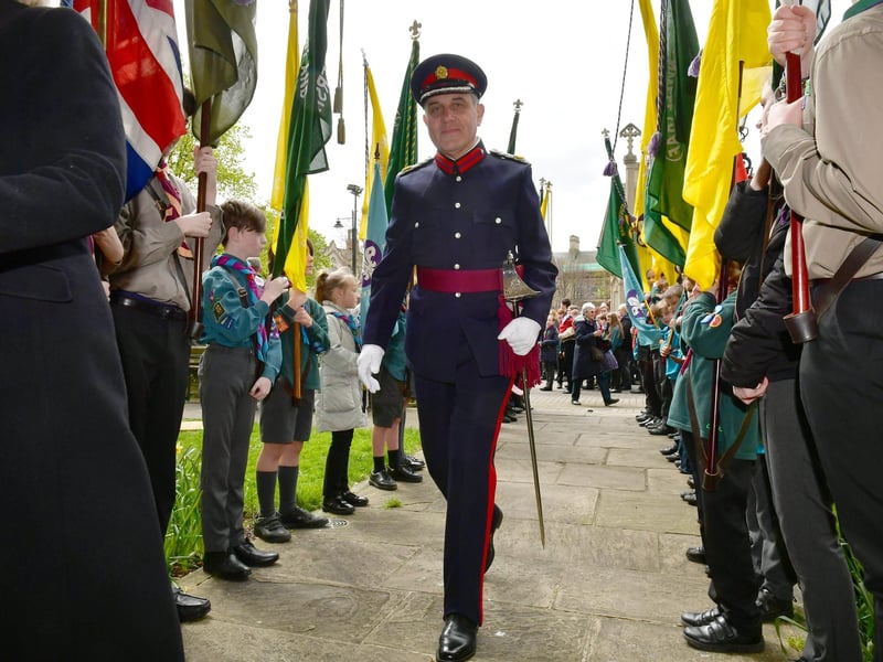 Charles Pinchbeck, Deputy Lord Lieutenant of Lincolnshire, heads into St Denys' Church between the rows of Scout standard bearers. Photo: David Dawson
