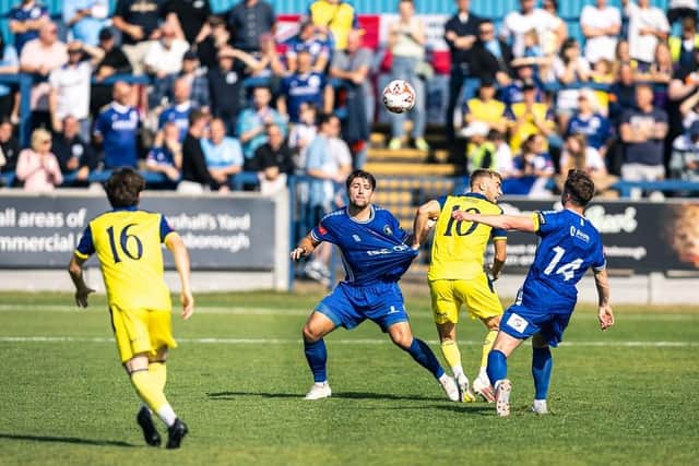 Trinity inthe midfield battle with Bury on Saturday. Photo by Sean Cook, Foxby Media.