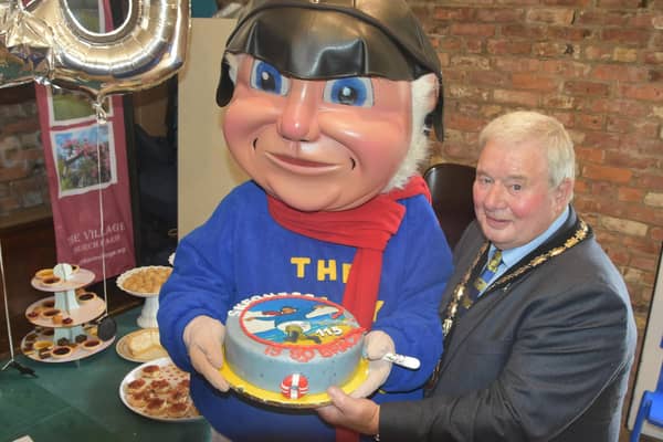 Mayor of Skegness Coun Pete Barry with the Jolly Fisherman and his 115th birthday cake. Photo: Barry Robinson.