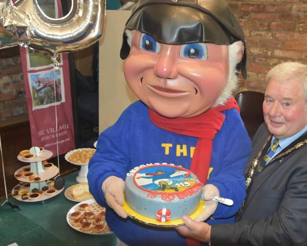 Mayor of Skegness Coun Pete Barry with the Jolly Fisherman and his 115th birthday cake. Photo: Barry Robinson.